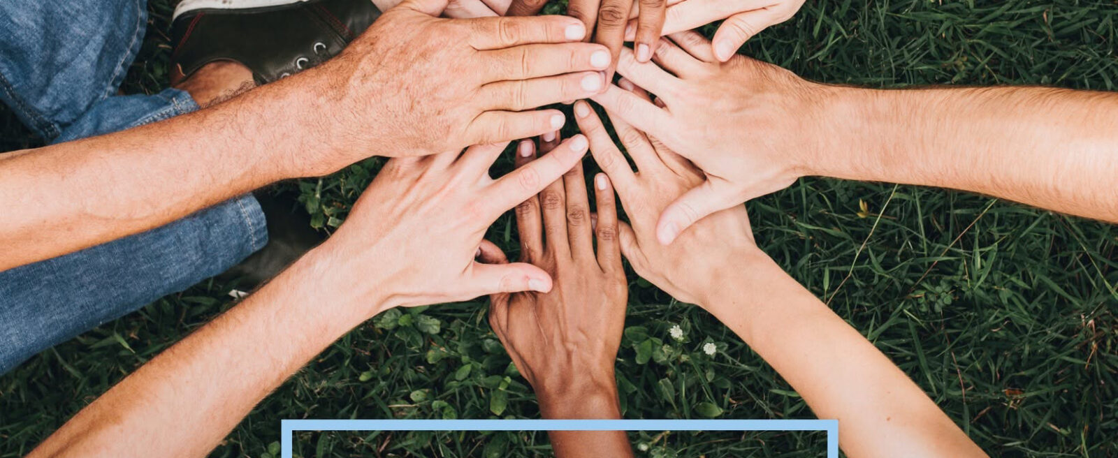 Diverse hands stacked in a circle on green grass, symbolizing teamwork and collaboration; overlaid with 'PROJEKT 1816' text on a poster.
